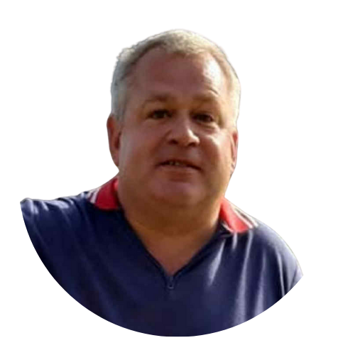 Portrait of Tony Jones, Sundowns Board Member, wearing a navy and red collared shirt.